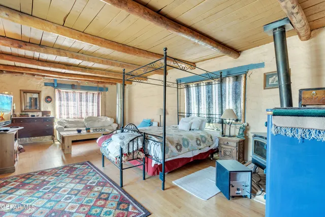 a bedroom with a bed window and flat screen tv