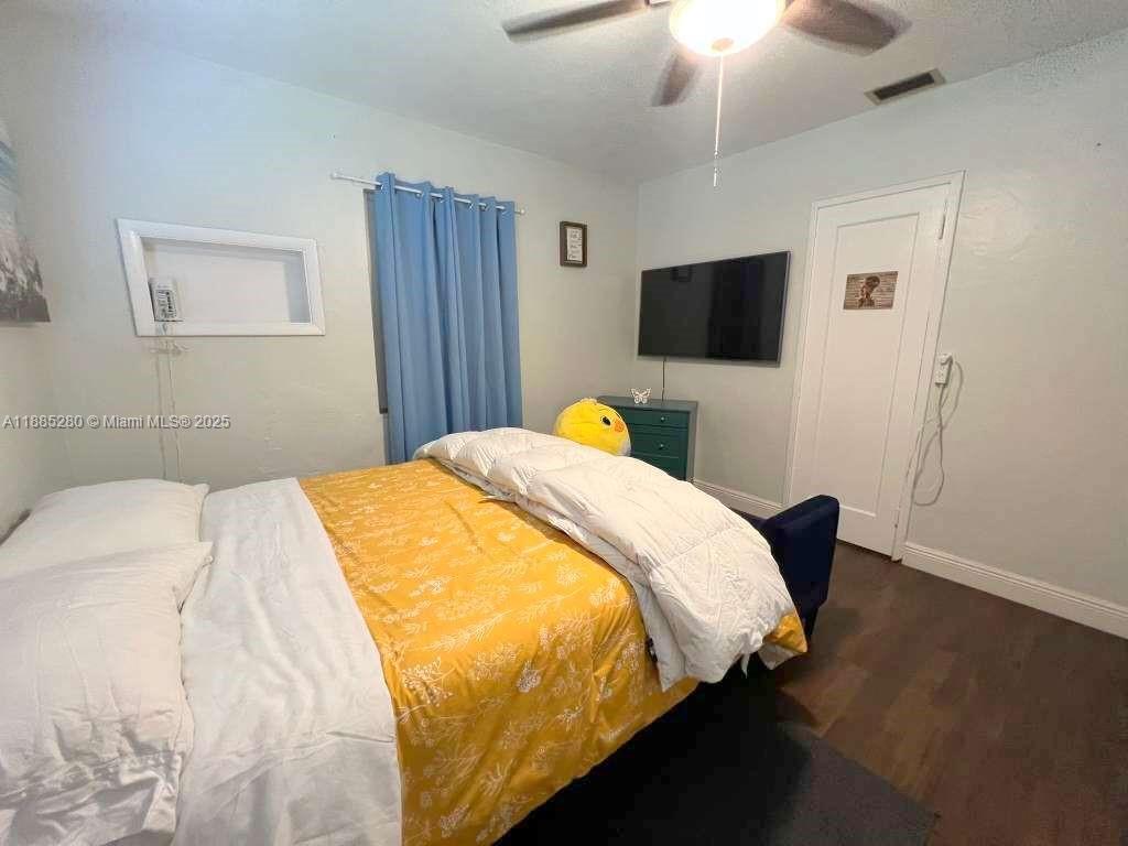 1130 Rutland Street Opa-Locka, FL 33054 - Photo 15 of 49 a bedroom with a bed and a flat screen tv