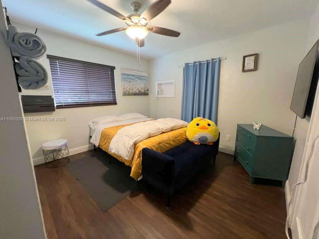 1130 Rutland Street Opa-Locka, FL 33054 - Photo 17 of 49 a bedroom with a bed dresser and a window