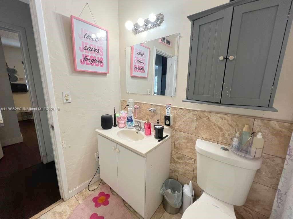 1130 Rutland Street Opa-Locka, FL 33054 - Photo 18 of 49 a bathroom with a sink toilet vanity and tub