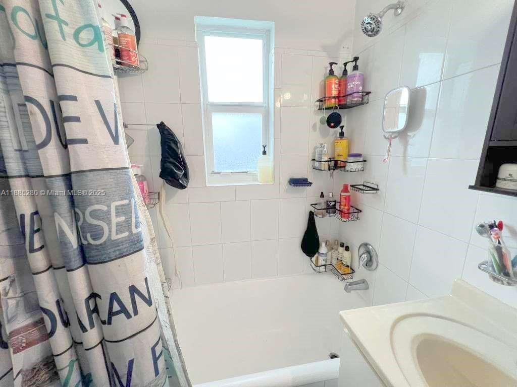 1130 Rutland Street Opa-Locka, FL 33054 - Photo 25 of 49 a bathroom with a sink vanity mirror bathtub and toilet