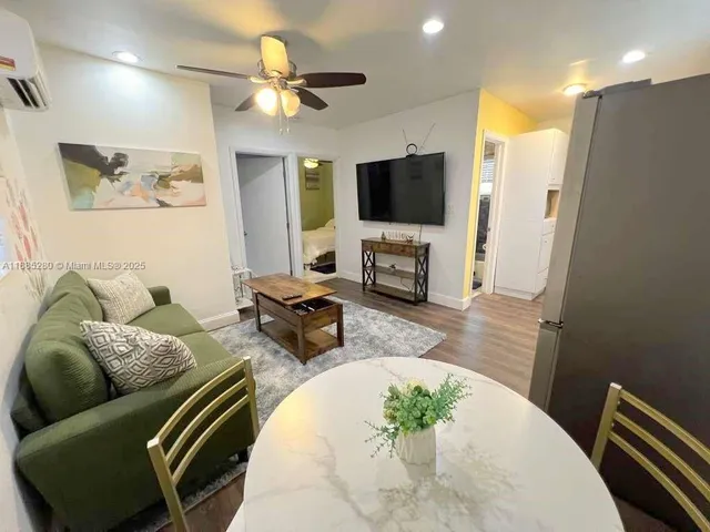 a living room with furniture flat screen tv and a fireplace