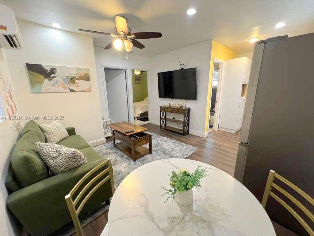 1130 Rutland Street Opa-Locka, FL 33054 - Photo 36 of 49 a living room with furniture flat screen tv and a fireplace