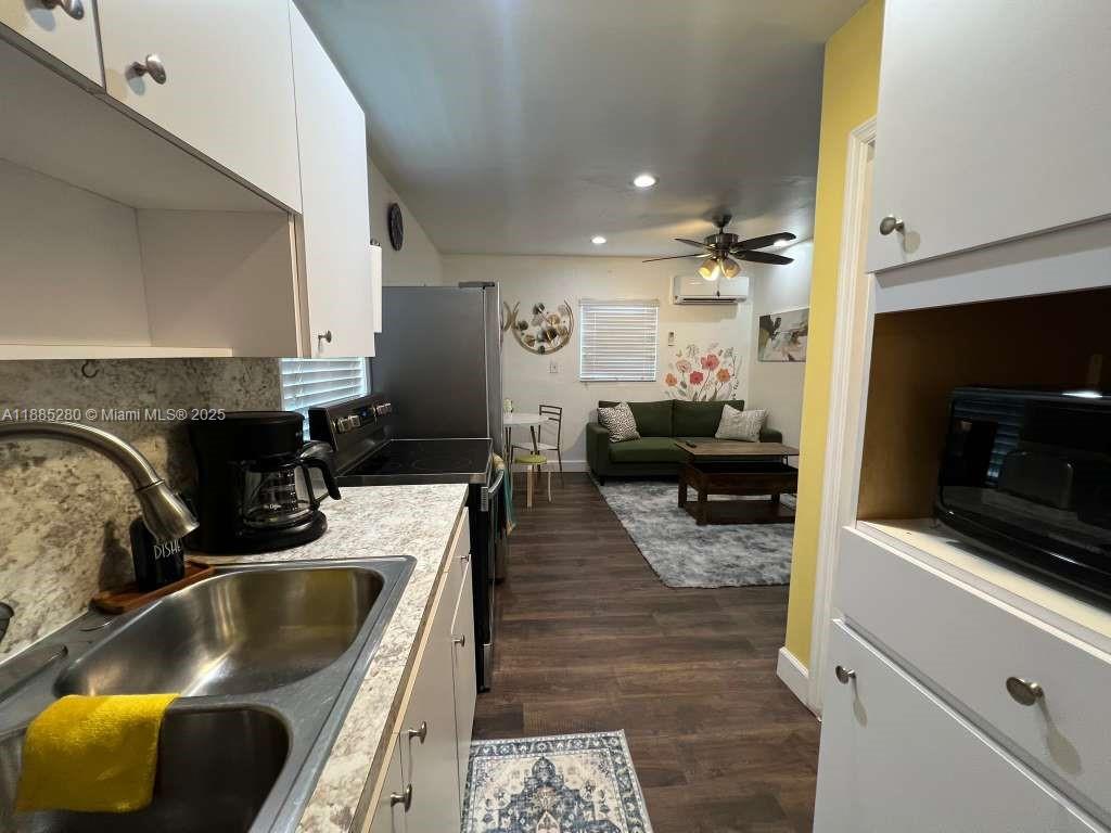 1130 Rutland Street Opa-Locka, FL 33054 - Photo 38 of 49 a kitchen with a sink and a stove top oven