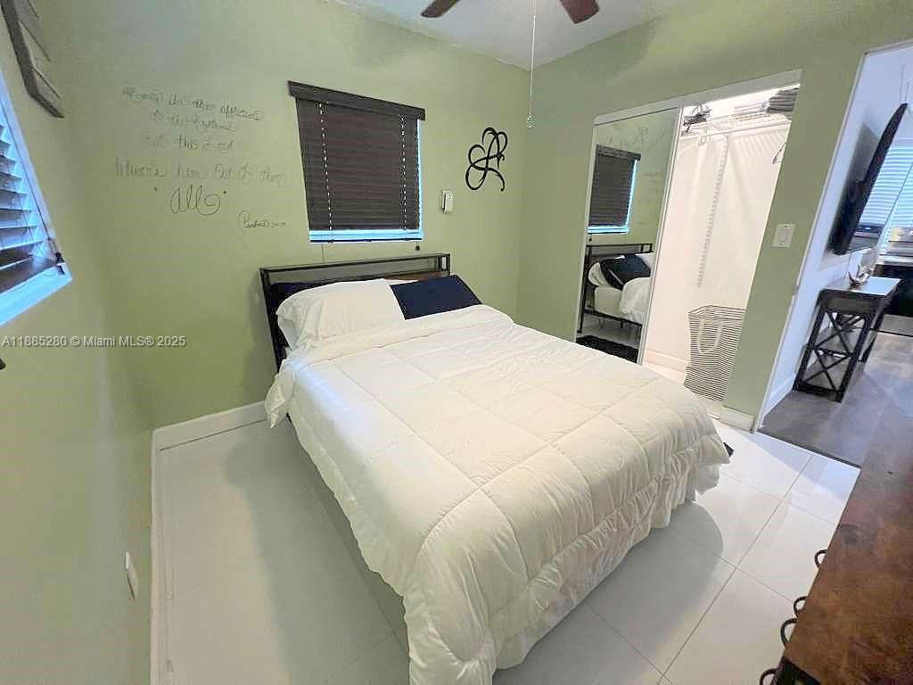 1130 Rutland Street Opa-Locka, FL 33054 - Photo 40 of 49 a bed sitting in a bedroom next to a window
