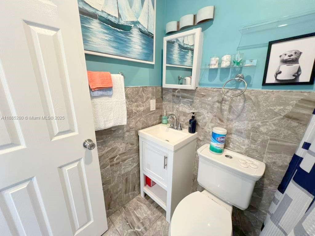 1130 Rutland Street Opa-Locka, FL 33054 - Photo 42 of 49 a white toilet sitting next to a bathroom sink