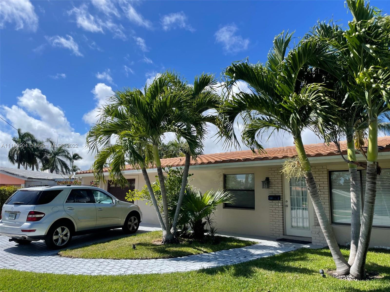 400 Southwest 14th Place Boca Raton, FL 33432 - Photo 1 of 29 a front view of a house with garden