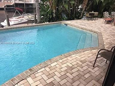 400 Southwest 14th Place Boca Raton, FL 33432 - Photo 16 of 29 a backyard of a house with table and chairs