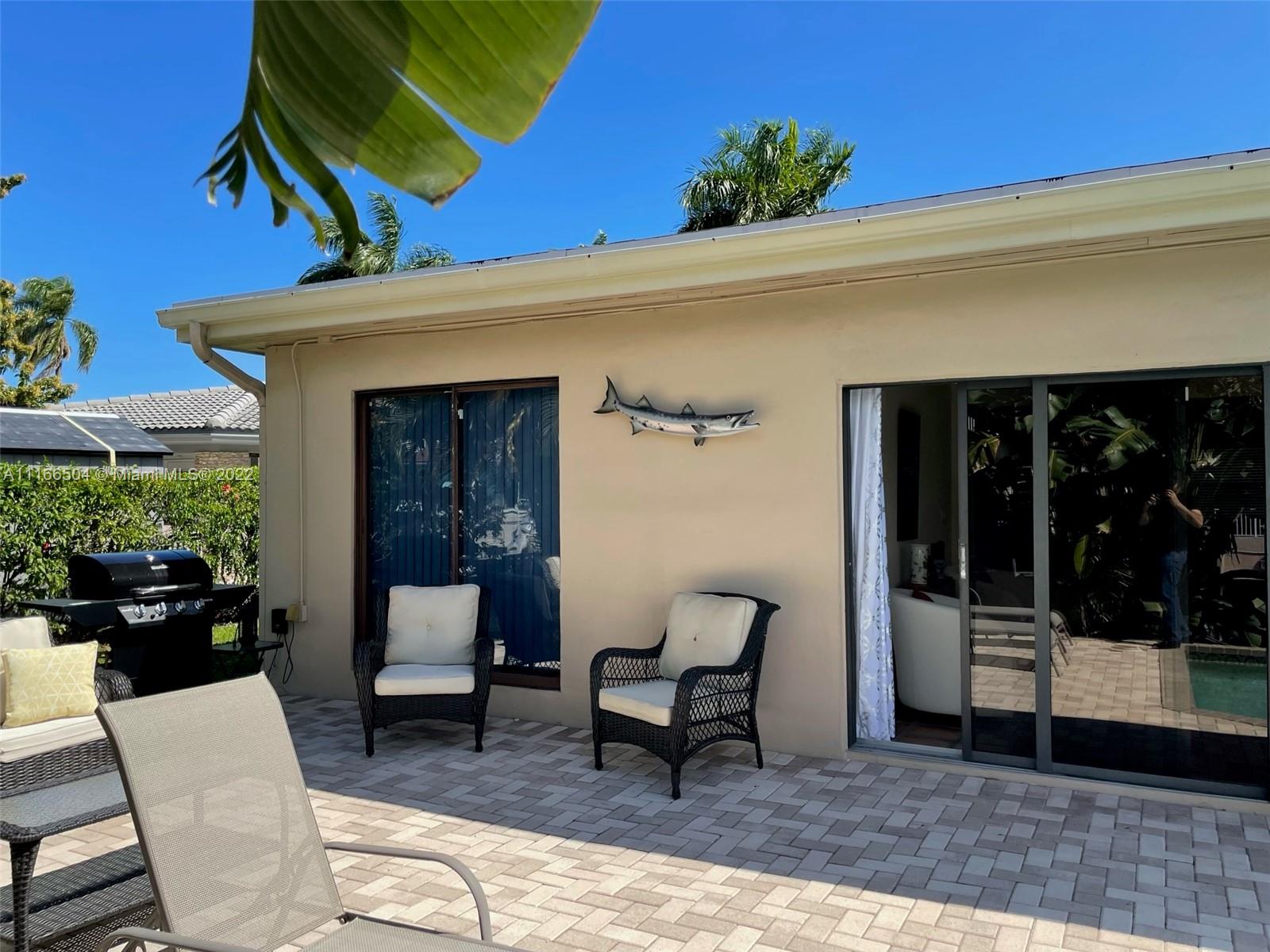 400 Southwest 14th Place Boca Raton, FL 33432 - Photo 23 of 29 a view of a patio with a table and chairs and potted plants