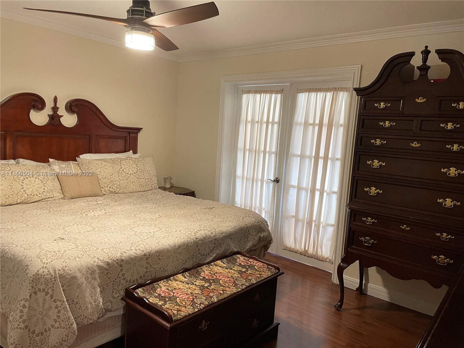 400 Southwest 14th Place Boca Raton, FL 33432 - Photo 8 of 29 a bedroom with a bed and a dresser