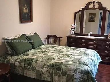 400 Southwest 14th Place Boca Raton, FL 33432 - Photo 9 of 29 a bedroom with a bed and a mirror