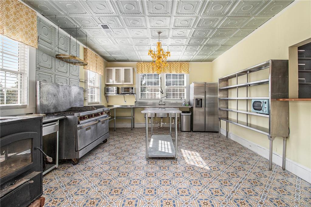 1208 North Broad Street Rome, GA 30161 - Photo 12 of 63 a kitchen with stainless steel appliances granite countertop a stove a sink and a refrigerator