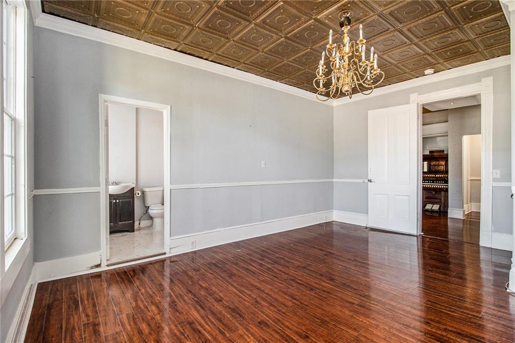 1208 North Broad Street Rome, GA 30161 - Photo 20 of 63 an empty room with wooden floor chandelier and windows