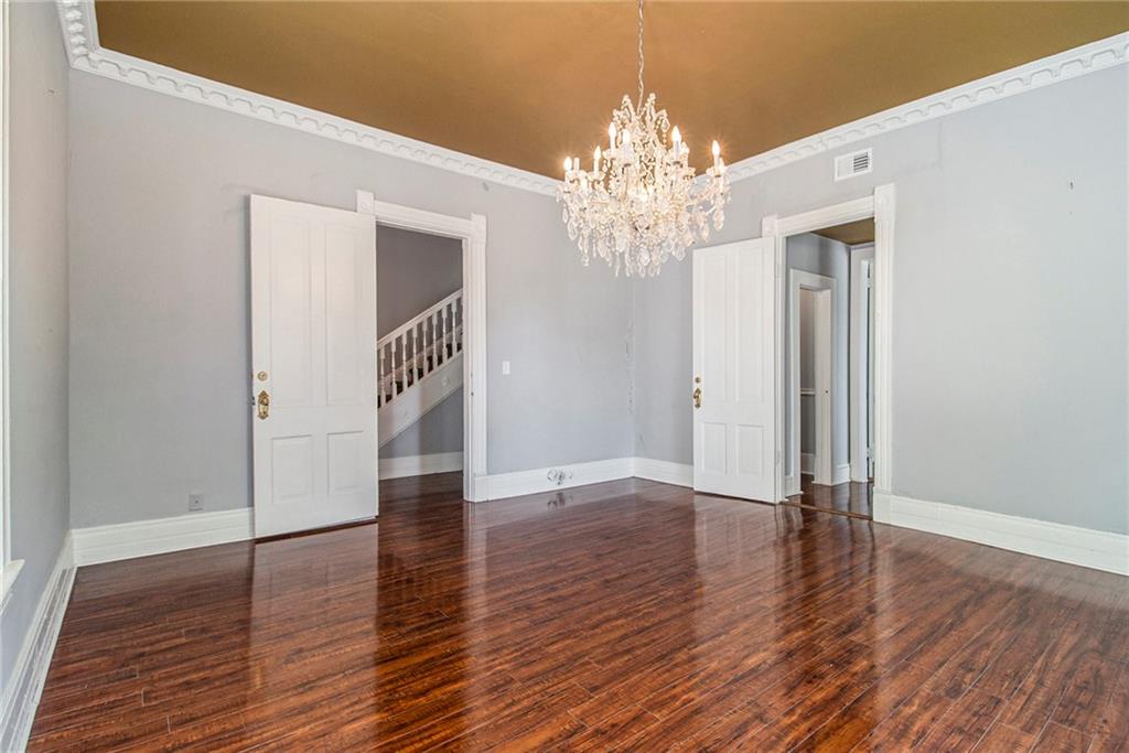 1208 North Broad Street Rome, GA 30161 - Photo 23 of 63 a view of a hallway with wooden floor and chandelier