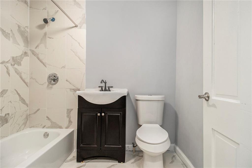 1208 North Broad Street Rome, GA 30161 - Photo 31 of 63 a bathroom with a sink toilet and bathtub