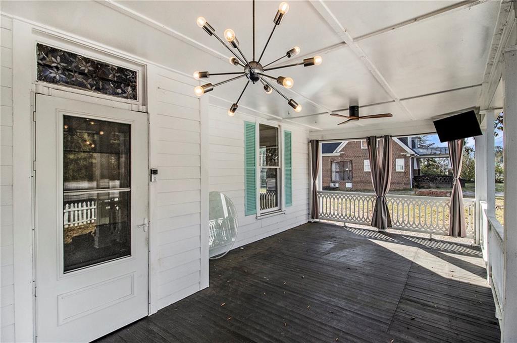 1208 North Broad Street Rome, GA 30161 - Photo 6 of 63 a view of a porch with wooden floor and a fireplace