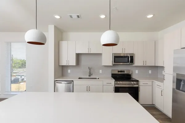 a kitchen with a refrigerator sink and microwave