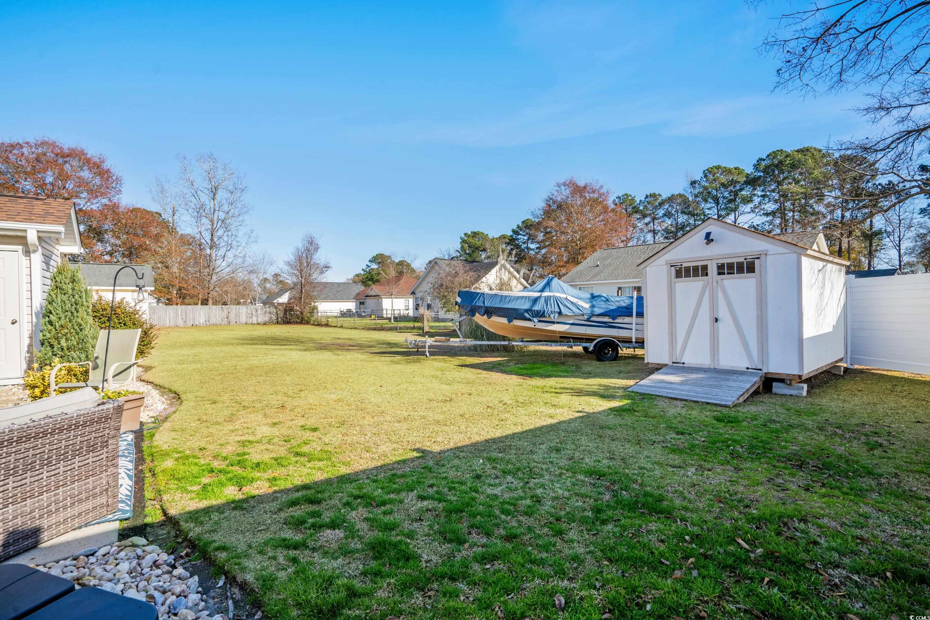 300 Kildare Court Myrtle Beach, SC 29588 - Photo 11 of 26 View of yard featuring a shed and cooling unit