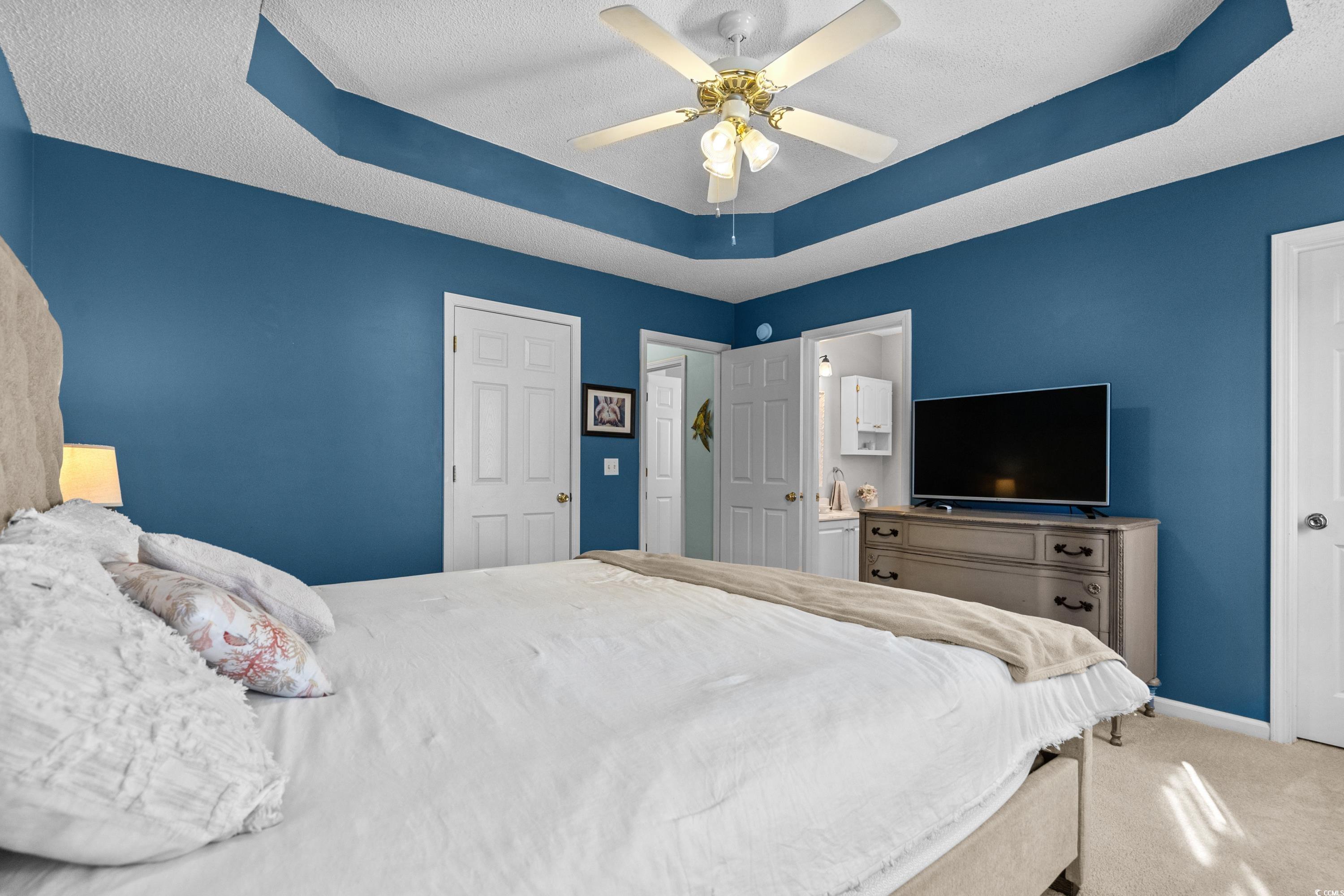 300 Kildare Court Myrtle Beach, SC 29588 - Photo 13 of 26 Carpeted bedroom with ceiling fan, connected bathr
