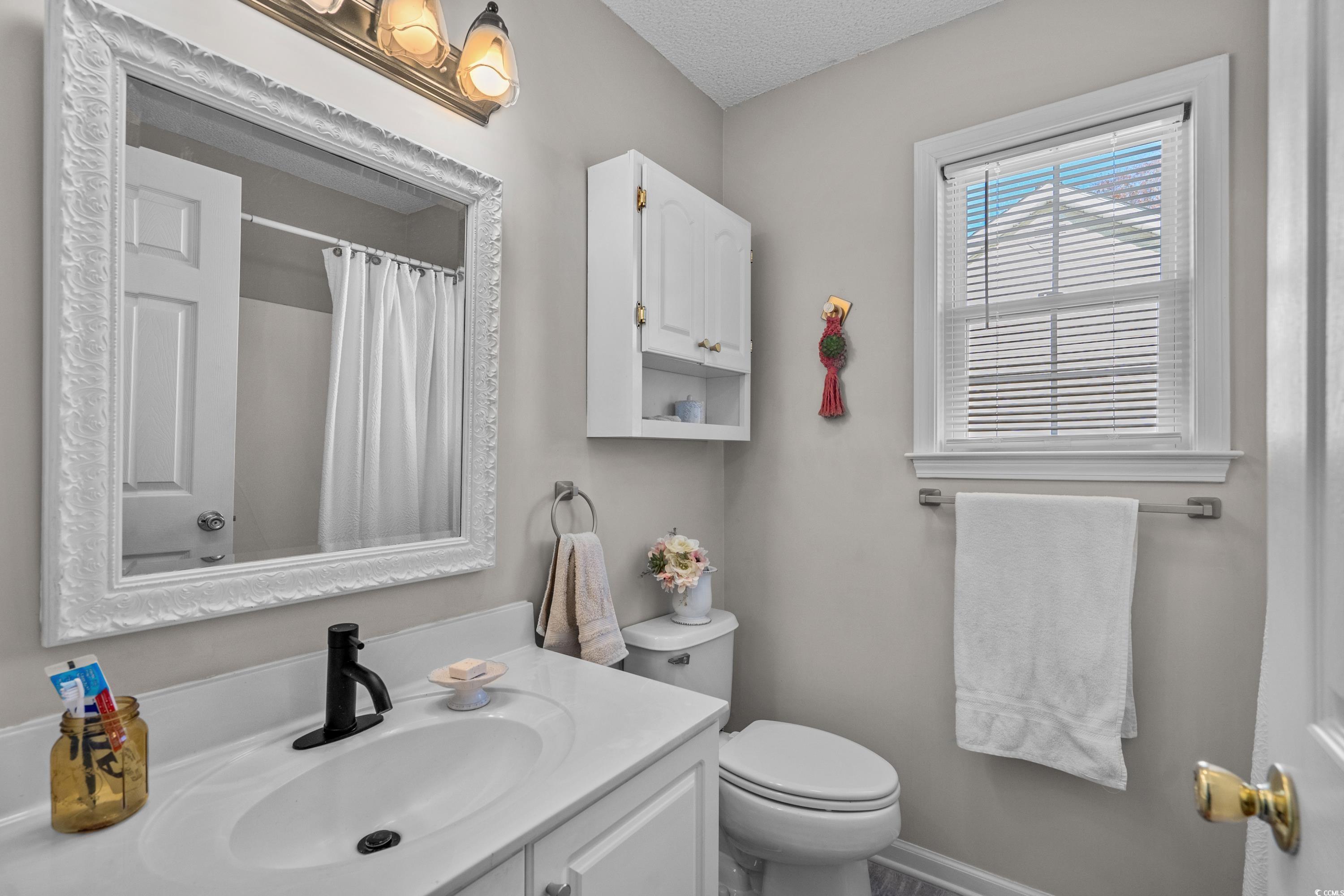 300 Kildare Court Myrtle Beach, SC 29588 - Photo 14 of 26 Bathroom featuring vanity, toilet, a shower with s