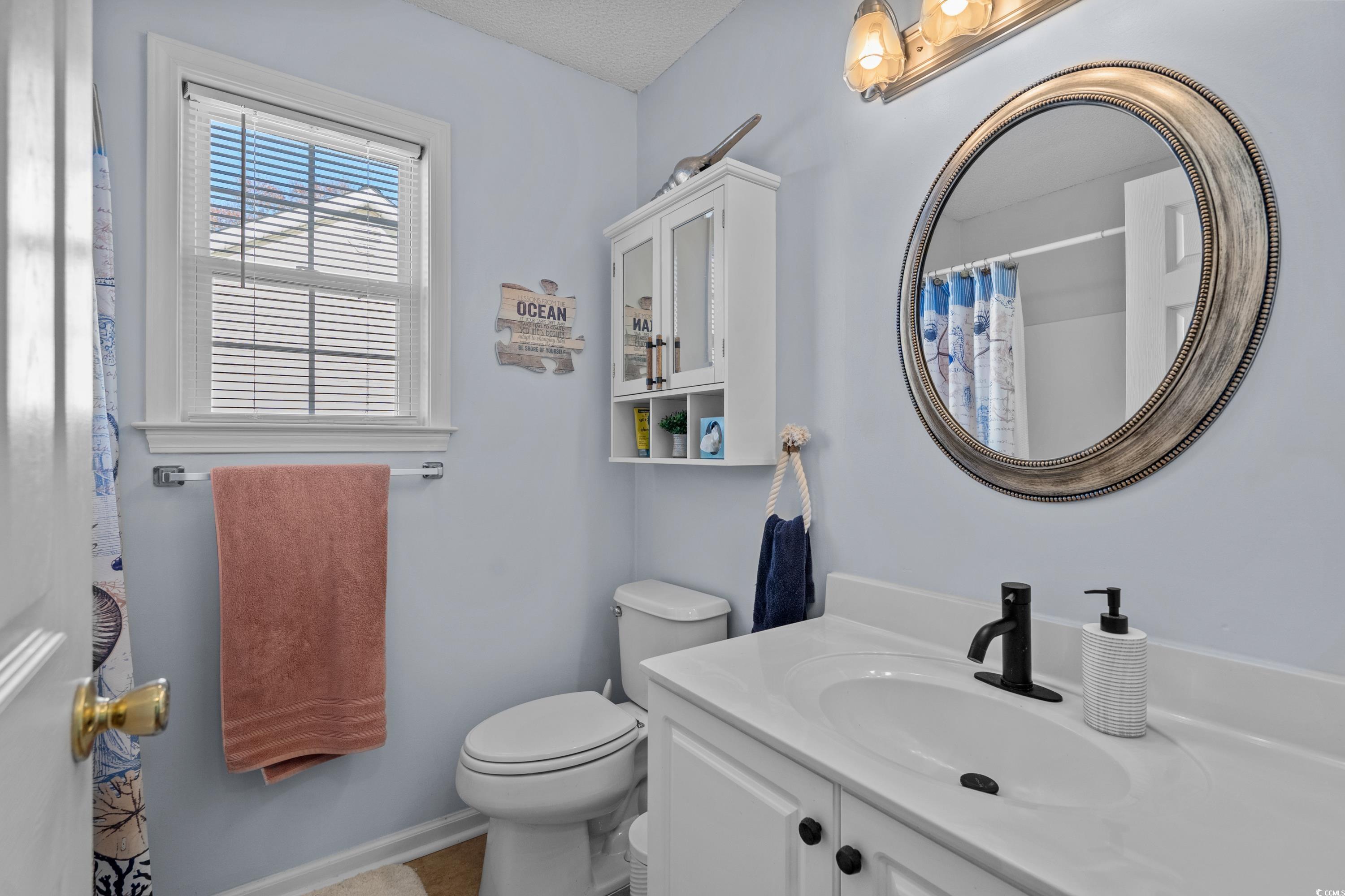 300 Kildare Court Myrtle Beach, SC 29588 - Photo 17 of 26 Bathroom with vanity, curtained shower, and toilet