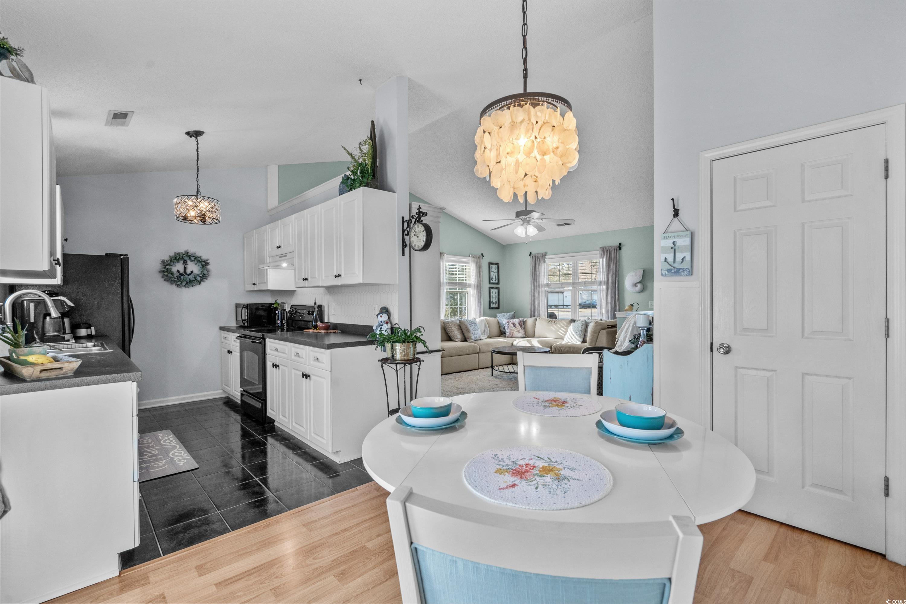 300 Kildare Court Myrtle Beach, SC 29588 - Photo 7 of 26 Kitchen featuring lofted ceiling, sink, white cabi
