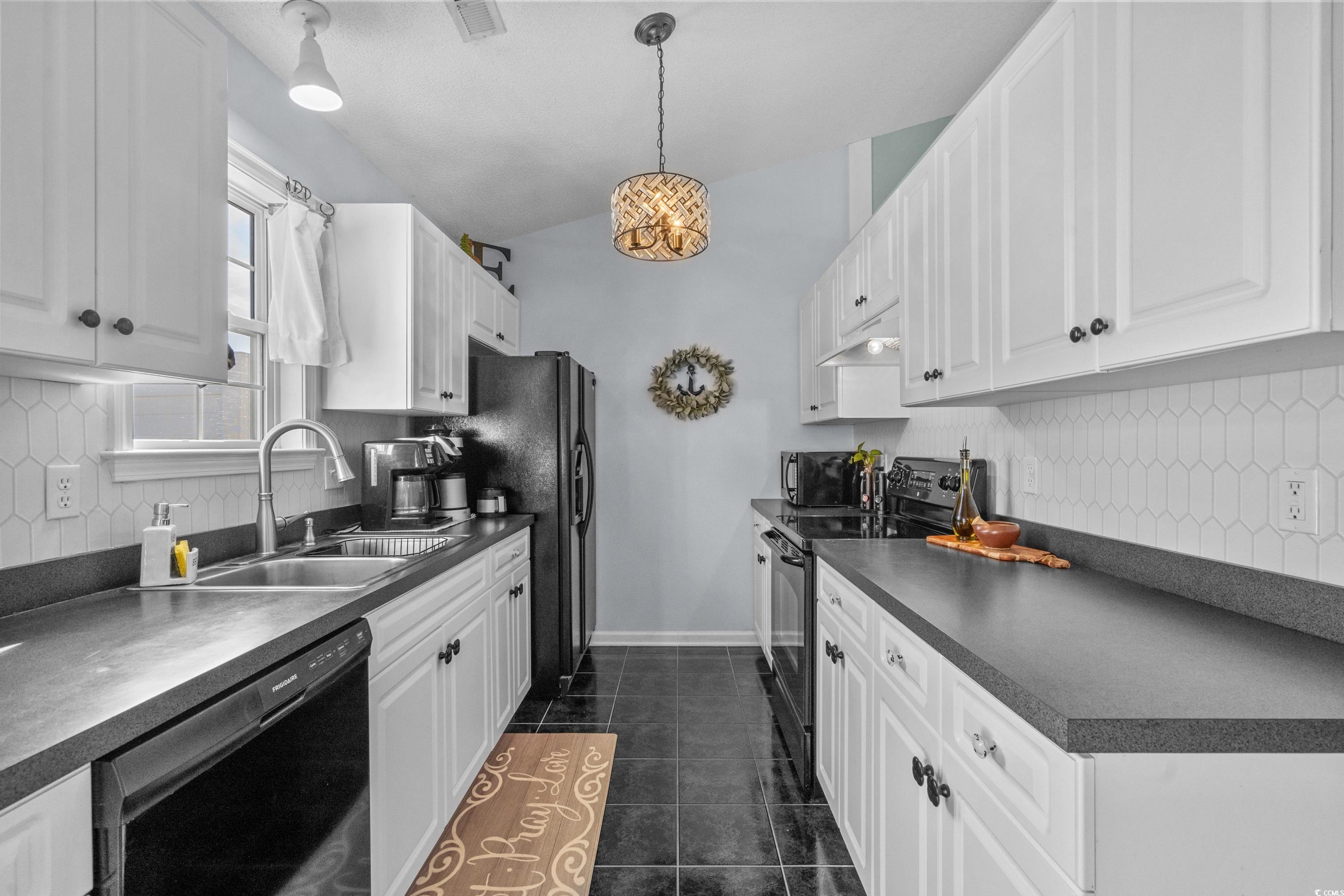300 Kildare Court Myrtle Beach, SC 29588 - Photo 8 of 26 Kitchen with white cabinetry, dark tile patterned