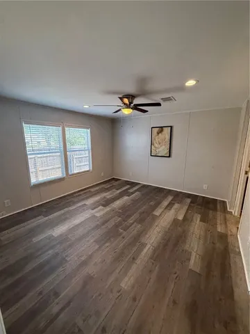 a view of an empty room and a window