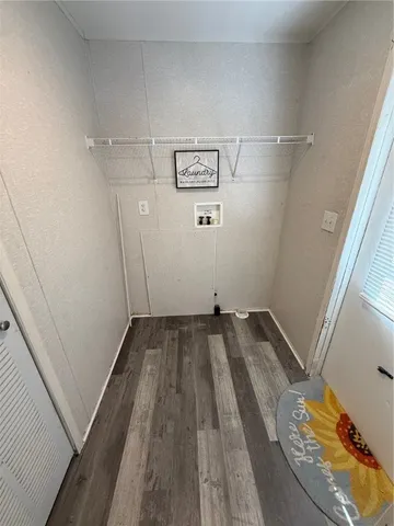 a view of a room with wooden floor