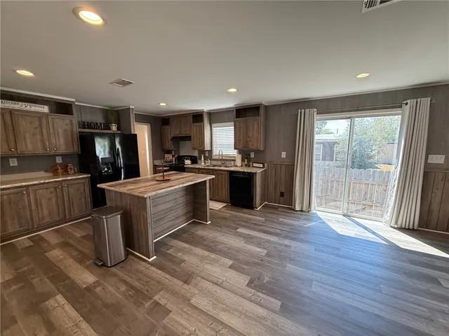 a kitchen with refrigerator cabinets and wooden floor