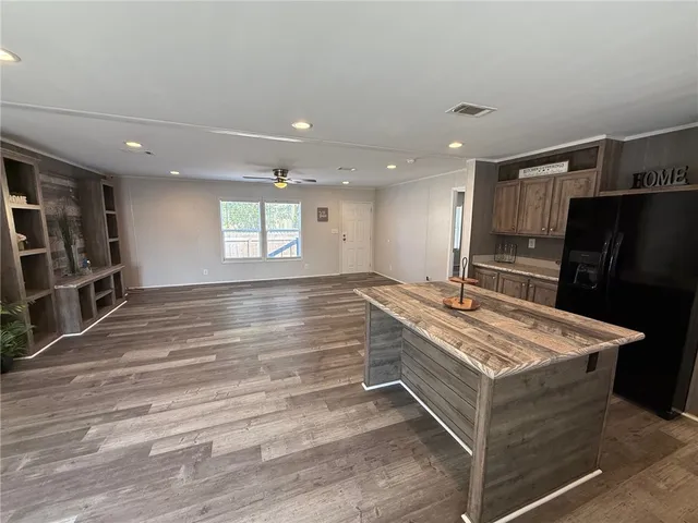 a room with pool table and a refrigerator