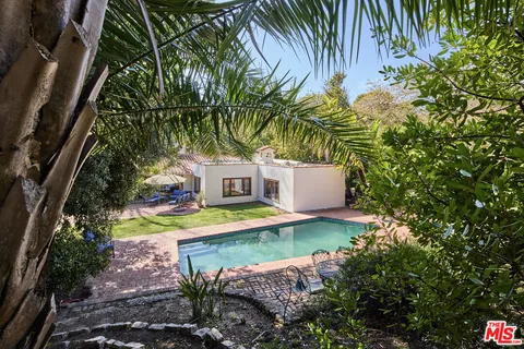 a view of a house with pool and a yard