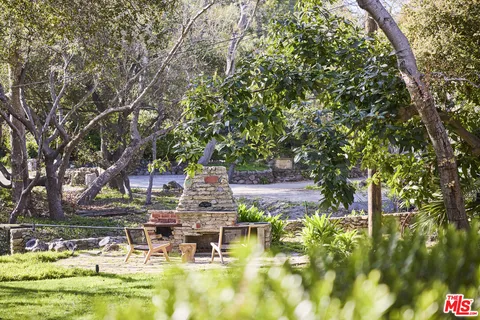 a view of swimming pool with outdoor seating and trees