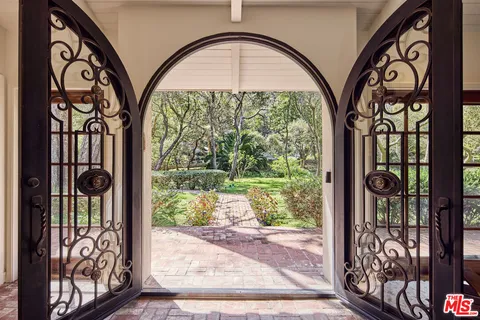 a view of entryway with a front door and wooden floor