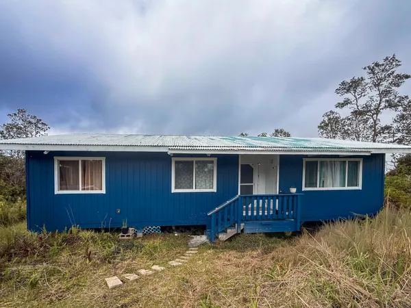 a view of a house with wooden fence