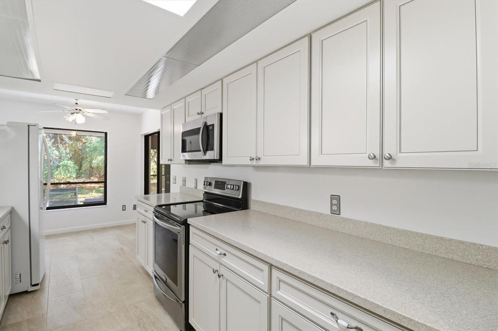 98 Sycamore Circle Homosassa, FL 34446 - Photo 12 of 34 a kitchen with stainless steel appliances a sink stove and microwave