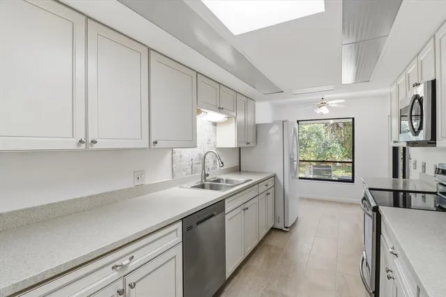 a kitchen with a sink stove and cabinets