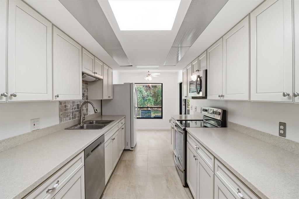 98 Sycamore Circle Homosassa, FL 34446 - Photo 14 of 34 a kitchen with stainless steel appliances a sink stove and cabinets
