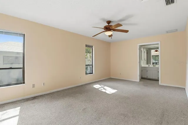 a view of room with a ceiling fan and window