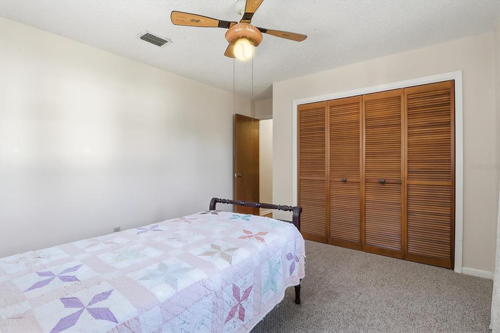 98 Sycamore Circle Homosassa, FL 34446 - Photo 20 of 34 a bedroom with a bed and a chandelier