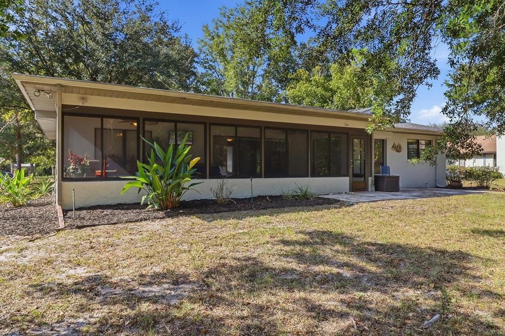 98 Sycamore Circle Homosassa, FL 34446 - Photo 27 of 34 a front view of house with yard and trees in the background