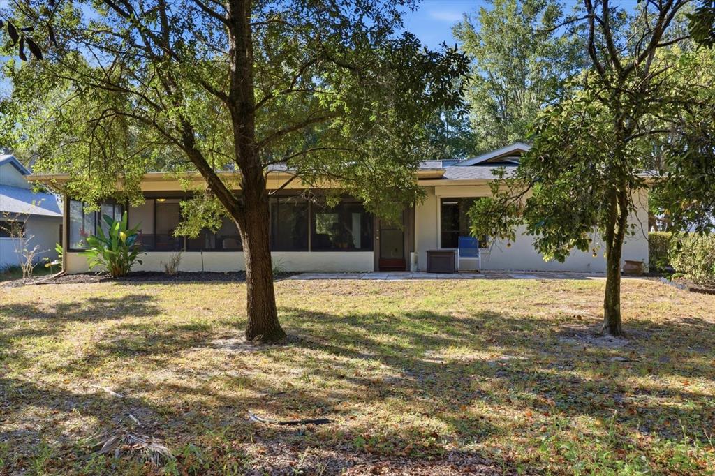 98 Sycamore Circle Homosassa, FL 34446 - Photo 28 of 34 a tree in front of a white house