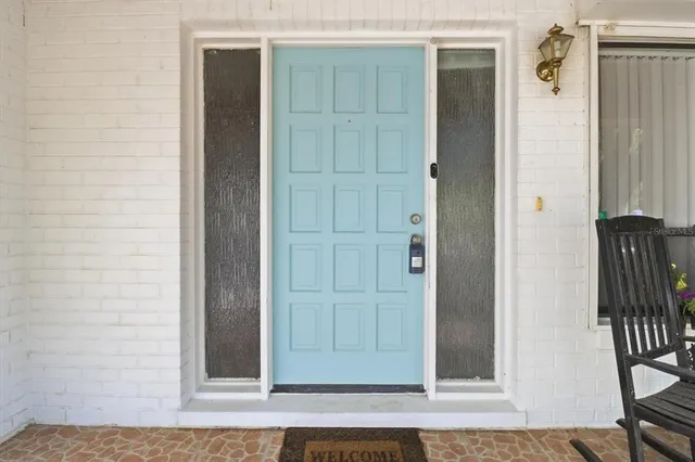 an entrance door view with wooden floor
