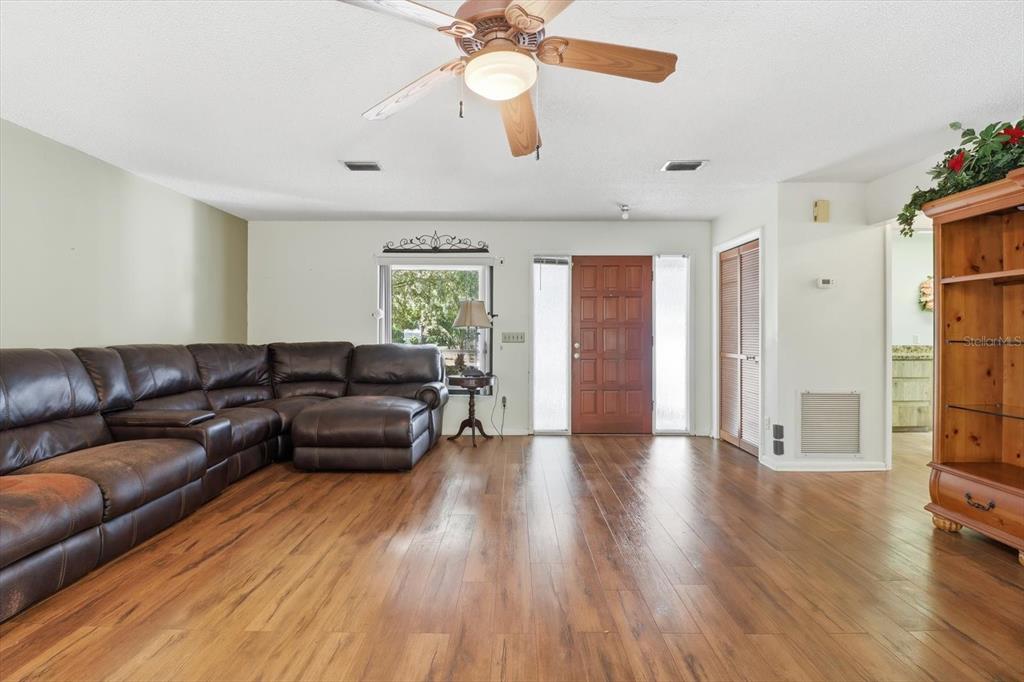 98 Sycamore Circle Homosassa, FL 34446 - Photo 5 of 34 a living room with furniture and a wooden floor