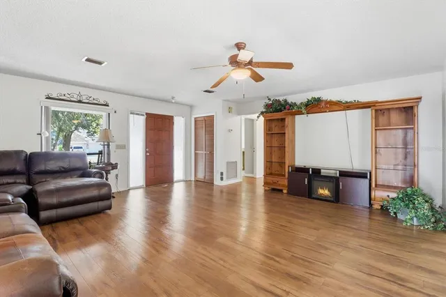 a living room with furniture and wooden floor