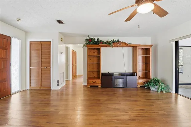 a view of a livingroom with furniture and hardwood floor