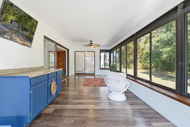 a large room with wooden floor and windows