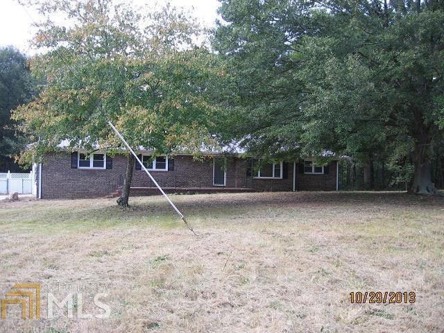 139 Patrick Mill Road Southwest Winder, GA 30680 - Photo 1 of 1 a backyard of a house with a table and a slide