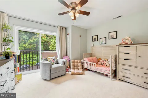 a living room with furniture and baby bed