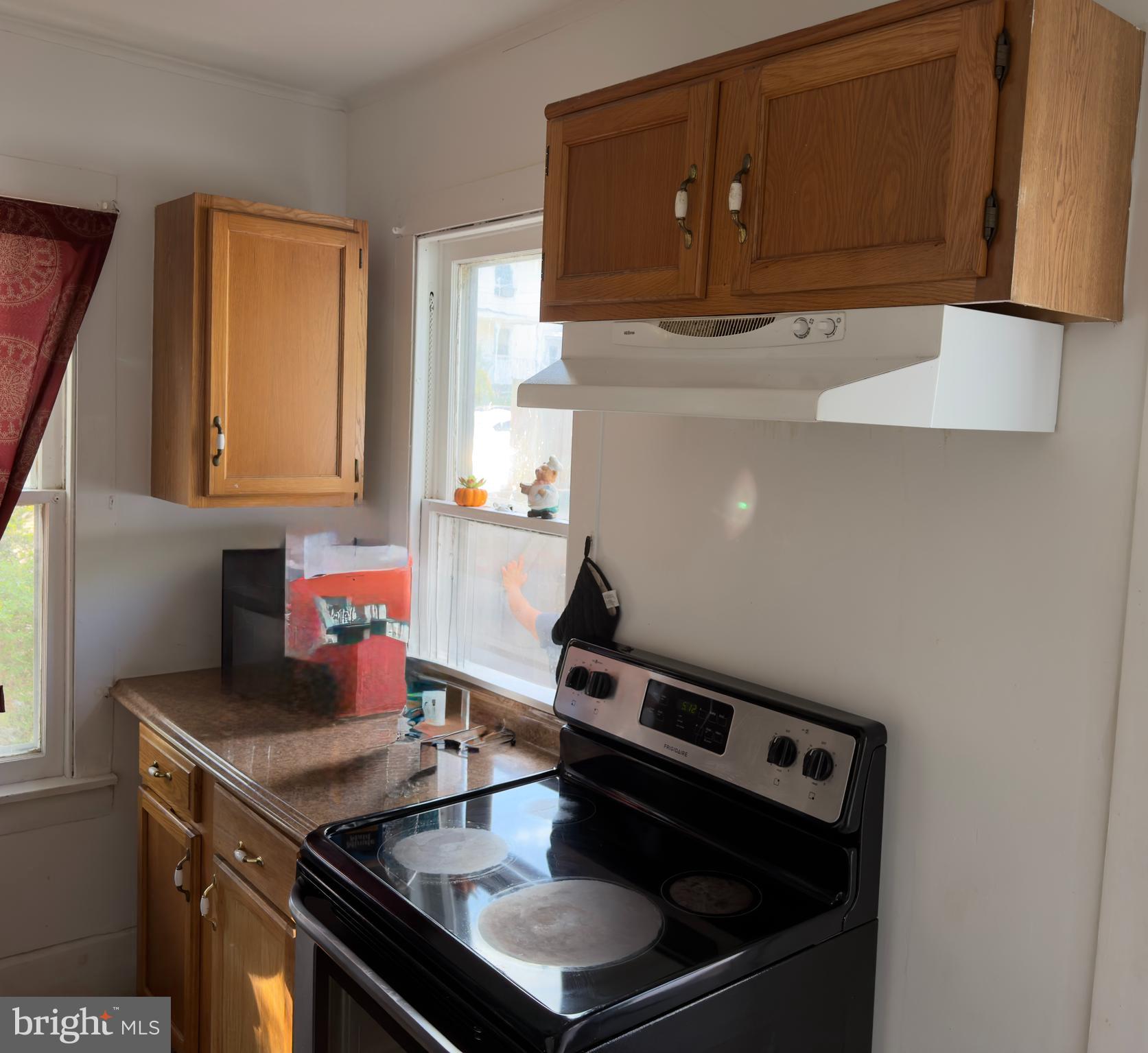 141 Hampton Street Bridgeton, NJ 08302 - Photo 10 of 18 a kitchen with a stove and a microwave